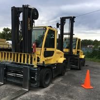 Two large Hyster forklifts at a service location